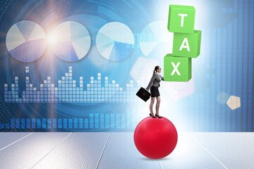 Tax concept with balancing businessman