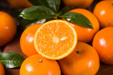 Fresh mandarin oranges or tangerines on wooden table.