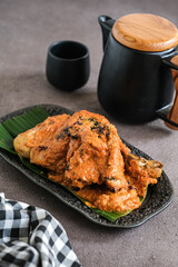 ayam bakar padang or padang grilled chicken from west sumatera. cooked with more spices.
