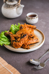 ayam bakar padang or padang grilled chicken from west sumatera. cooked with more spices.
