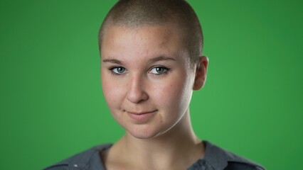 Fototapeta premium Portrait of confident successful happy gender fluid, non binary woman 20s isolated on green screen background in studio closeup slow motion