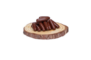 Brown Drug capsule put on a small wooden cutting board isolated on cutout PNG. Medicine is a capsule pill. Vitamin strengthens immune system. Body's immune response after the vaccine is good. 