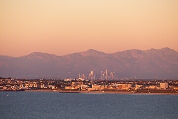 On a particularly clear day, the skyline of Los Angeles, with the towering San Gabriel Mountains in...