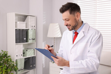 Naklejka na ściany i meble Doctor with clipboard in clinic. Patient consultation