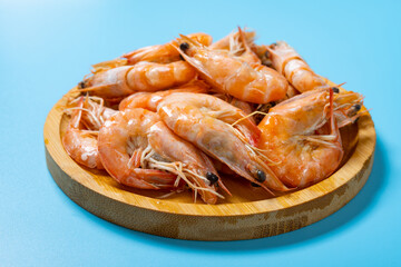 angle view fresh cooked shrimps on blue