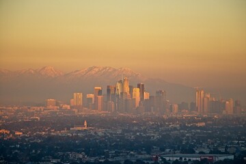 Snow tops the San Gabriel Mountains that tower above Los Angeles as evening falls on the city.