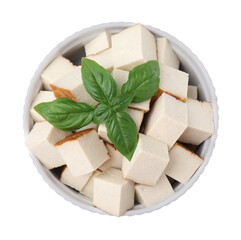 Bowl of delicious smoked tofu cubes with basil isolated on white, top view