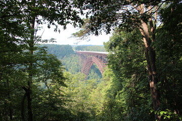 View through the trees of the New River Gorge Bridge in Fayetteville, West Virginia.