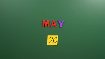 Hand sticking a sticker 26 May calendar day on school board. 26 date of May. Twenty sixth day of May. 26th date number. 26 day calendar. Twenty six date. Georgia independence, Independence of Guyana