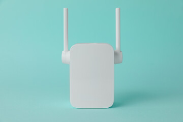 New modern Wi-Fi repeater on turquoise background