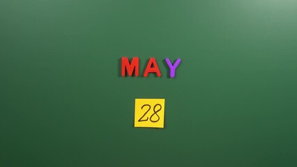 Hand sticking a sticker 28 May calendar day on school board. 28 date of May. Twenty eighth day of May. 28th date number. 28 day calendar. Twenty eight date. Azerbaijan Republic, Armenia Republic, Worl