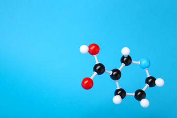 Molecule of vitamin B3 on light blue background, space for text. Chemical model