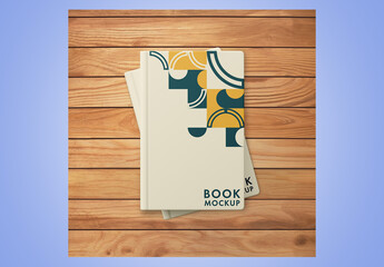 Two Book Covers on Wooden Surface