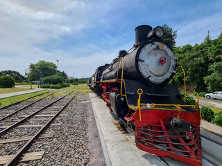 Tourist travel steam locomotive parked outdoors