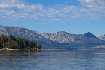Parasailers and boaters begin their mornings on the peaceful waters of Lake Tahoe in the Sierra Nevada Mountains.