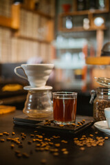 a cup of coffee on the scale with the v60 next to it on the bar desk