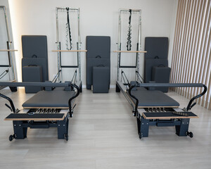 Two reformer machines. Pilates studio without people. 