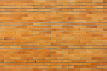 An abstract image of the reddish brown texture on an exterior brick wall. 