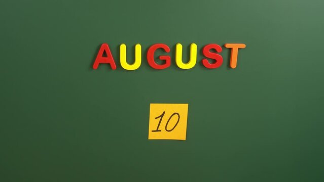 Hand sticking a sticker 10 August calendar day on school board. 10 date of  august. Tenth day of august. 10th date number. 10 day calendar. Ten date.  Independence day of Ecuador, Argentine Air Force