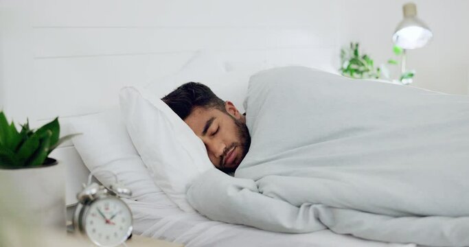Man, bed and sleeping in home for rest, wellness or recharge for body, mind and spirit for peace. Young, gen z guy and apartment bedroom for sleep, relax and health for dream, quiet or lying in house
