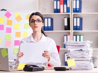 Young female employee in conflicting priorities concept