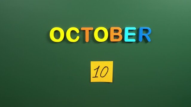 Hand sticking a sticker 10 October calendar day on school board. 10 date of October. Tenth day of October. 10th date number. 10 day calendar. Ten date. world mental health, Taiwan, Double Ten