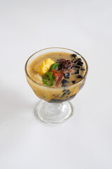 es campur or mixed ice is Indonesian dessert made from tapai cassava, cendol, red bean, jelly and palm seed, served with coconut milk, palm sugar and ice
