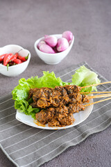 sate kerang, shell satay made from shell with spices like rendang. selective focus