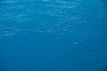 Blue ripped water in swimming pool, water pool texture and surface water backgraund.