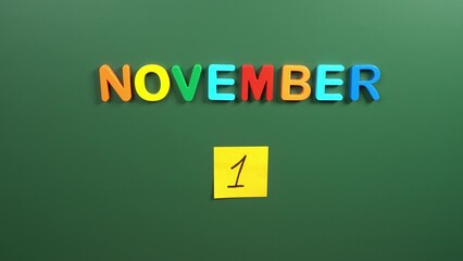 Hand sticking a sticker 1 November calendar day on school board. 1 date of November. First day of November. 1st date number. 1 day calendar. One date. All saints, world vegan