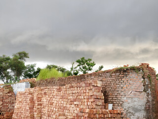The towering brick factory wall looms over the surrounding landscape, a reminder of the area's manufacturing heritage.
