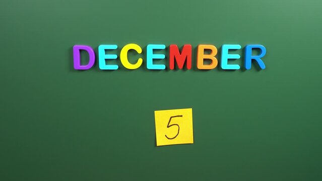 Hand sticking a sticker 5 December calendar day on school board. 5 date of December. Fifth day of December. 5th date number. 5 day calendar. Five date. World soil, International volunteer