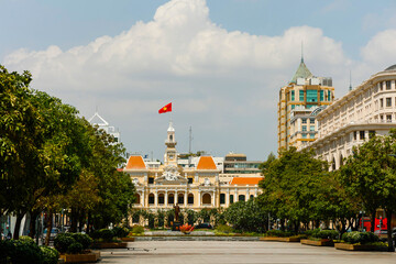 Naklejka premium Ho Chi Minh statue in front of City Hall, is known as Ho Chi Minh City People's Committee Head office Saigon. Popular place to visit in Saigon at day tour. Travel destinations in Vietnam 