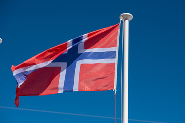 Waving flag of Norway with sunny day.