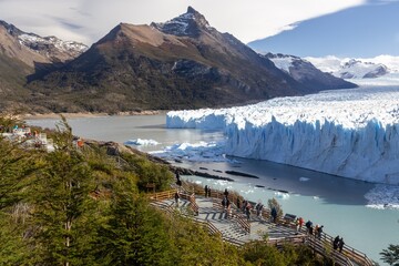 Tourist People Standing on Wooden Platform and Admiring Scenic Perito Moreno Glacier on a Sunny Day in Los Glaciares National Park, Patagonia Argentina