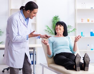 Fototapeta premium Old woman visiting young doctor dentist