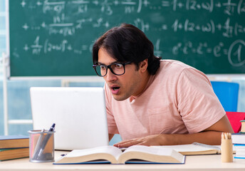 Young male student in the classroom