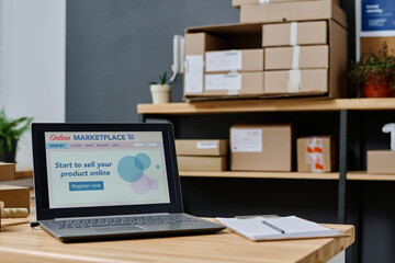 Homepage of online market place on screen of laptop standing on workplace of worker or manager of volunteering organization