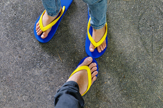 father and son showing slippers