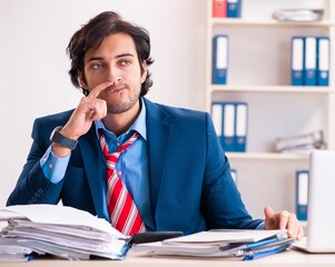 Young handsome businessman sitting in the office