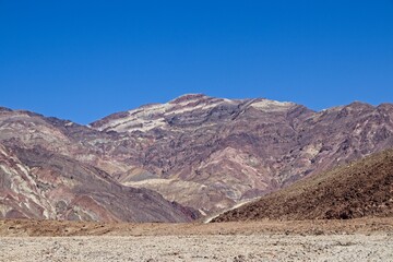 Driving along Artist's Drive, a one-way scenic loop in Death Valley, reveals rocks with a surprising number of colors. It is home to Artist's Pallette, which has a dusting of green and pink colors.
