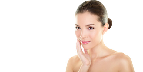 Beautiful Asian beauty woman touching perfect face skin laughing happy. Healthy skincare concept with candid smiling girl smiling at camera. Body care concept. Fresh mixed race Asian Caucasian 20s.
