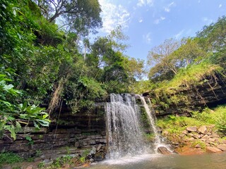 Waterfall in the gorge with blue sky above
