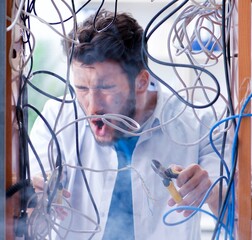 Electrician trying to untangle wires in repair concept