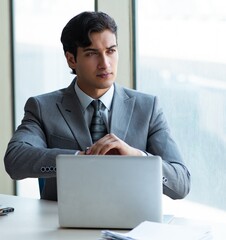 Young successful businessman working at the office