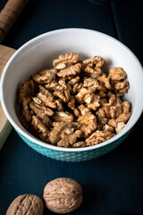 Walnut kernel halves, in a wooden bowl. Walnuts in wooden bowl. 