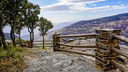 Fototapeta na wymiar Panoramic view of a valley in the Alpujarras of Granada with a white village in the background