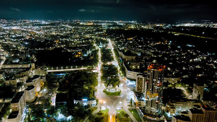 Saratov, Russia. Slavyanskaya Square. The text is translated as Saratov. Panorama of the night city, Aerial View