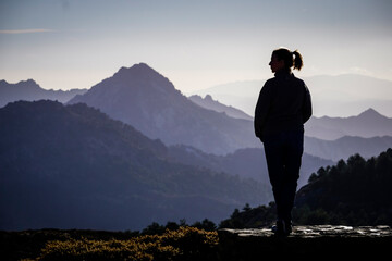 Fototapeta premium Young Caucasian woman dressed in jeans and sweatshirt enjoying the views of the Alpujarra valleys of Granada
