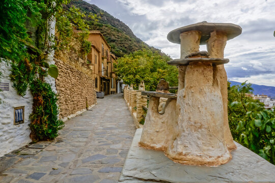street of a town in the Alpujarra of Granada with chimneys decorating the viewpoint of the street